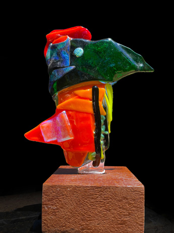 Kiln formed glass mounted on a wood base. 9.5 inch high.